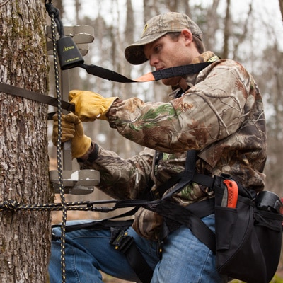 Deer hunter practicing treestand safety with an HSS harness and lifeline