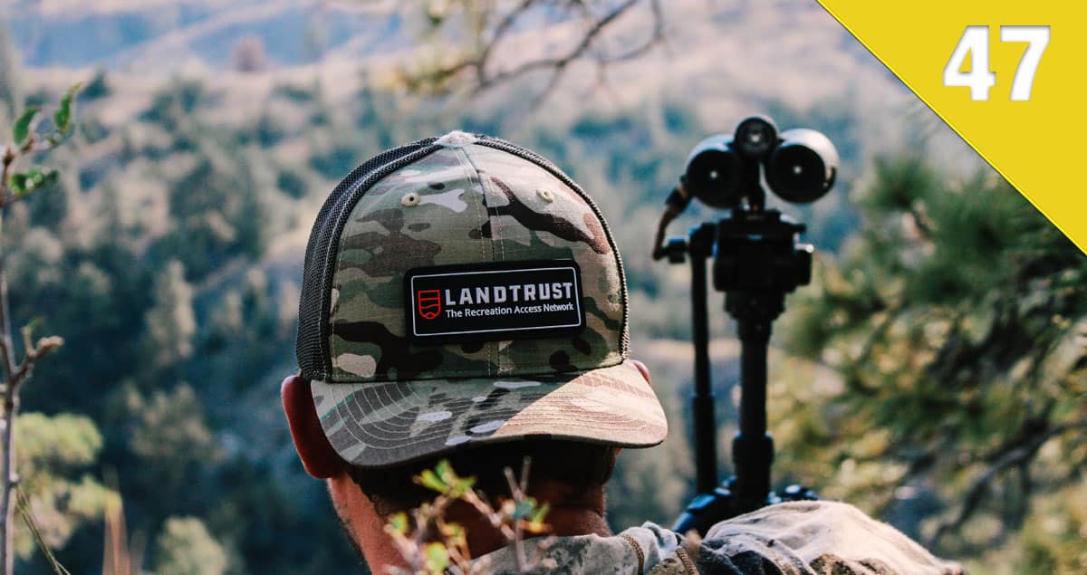 Cool shot of someone in a LandTrust cap overlooking a large expanse of grasslands.