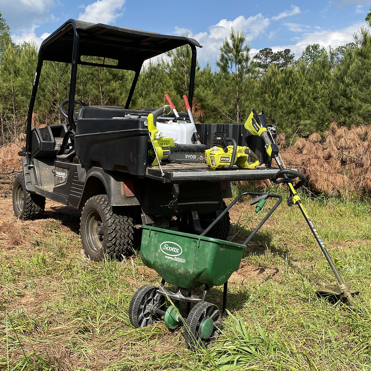 A Tracker utility vehicle loaded with hand tools used to manage a small hunting property.